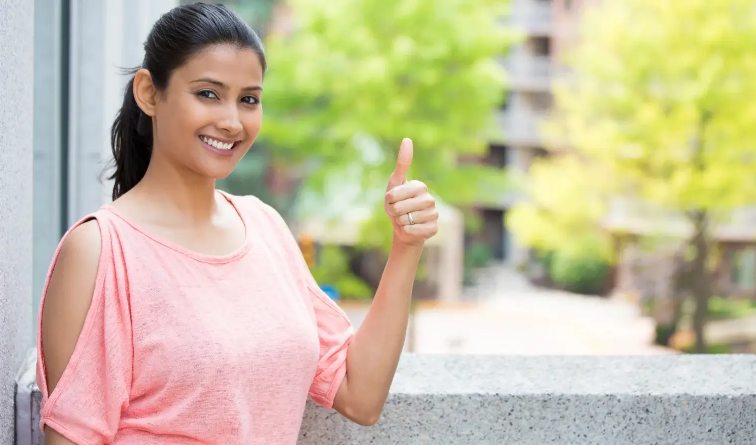 smiling lady doing thumbs up